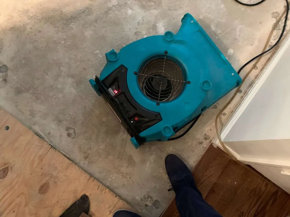 Air mover drying subfloor during Commercial Water Damage Restoration in New Garden